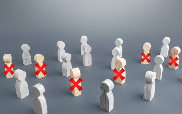 shutterstock_1716859621.jpg featured image Wooden figures with red X marks, signifying eliminated individuals.