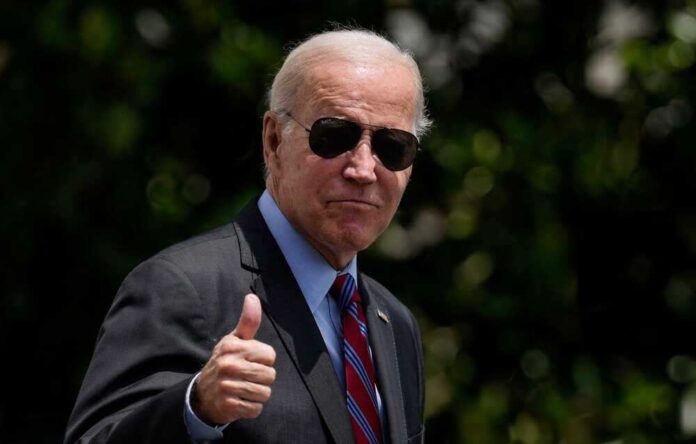 shutterstock_2442440857.jpg featured image Joe Biden in a suit and sunglasses giving thumbs up.