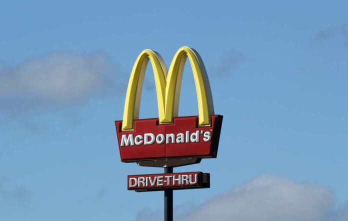 shutterstock_2433110395.jpg featured image McDonald’s drive-thru sign against a blue sky.