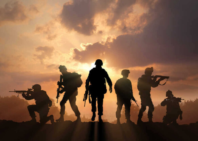 shutterstock_39855712011.jpg featured image Soldiers silhouetted against a sunset, holding weapons.