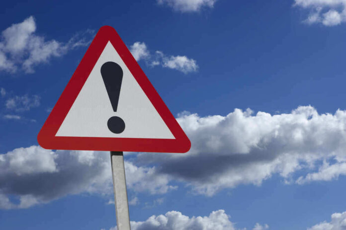 shutterstock_539658352.jpg featured image Warning sign with exclamation mark and blue sky background.