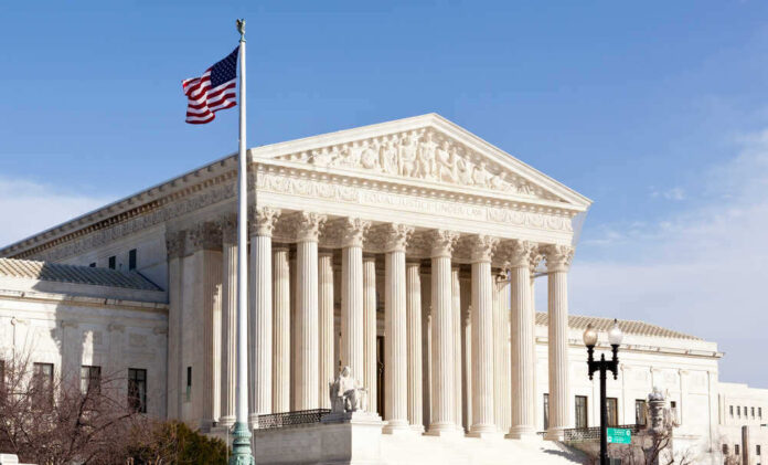 shutterstock_96721225.jpg featured image U.S. Supreme Court building with American flag.
