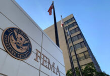 FEMA building with flags and blue sky backdrop