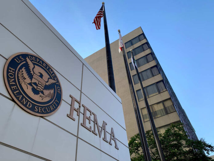 shutterstock_1819068767.jpg featured image FEMA building with flags and blue sky backdrop