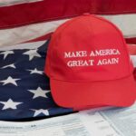 Red Make America Great Again hat on American flag