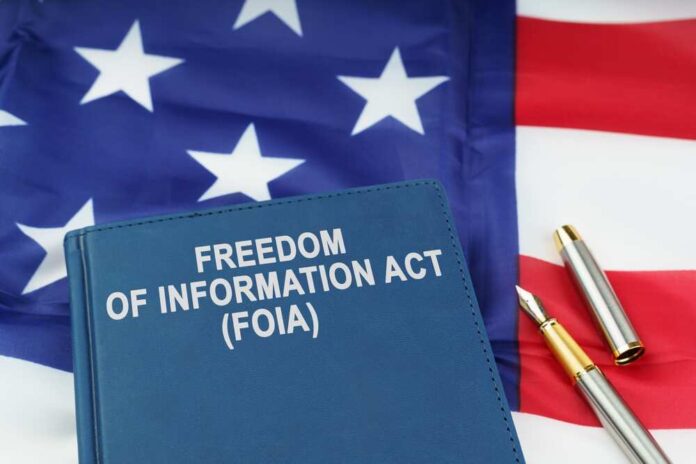 shutterstock_2247309787.jpg featured image Freedom of Information Act book on American flag