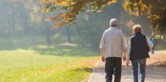 Two people walking together on a park path.