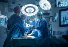 Doctors performing surgery in a modern operating room.