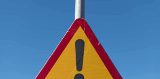 Triangular warning sign with exclamation mark.