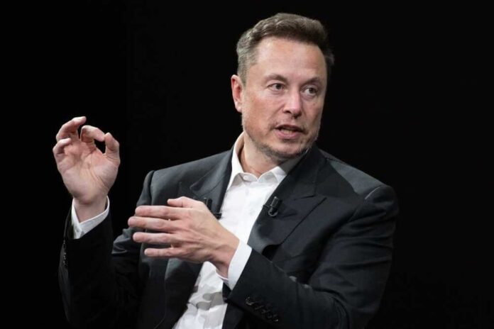 Elon Musk in a suit talking.