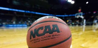 Close-up of NCAA basketball on court.