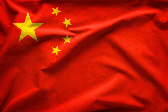 shutterstock_1286673253.jpg featured image Red flag with five yellow stars, China's flag.