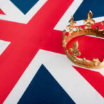 A golden crown resting on the Union Jack flag