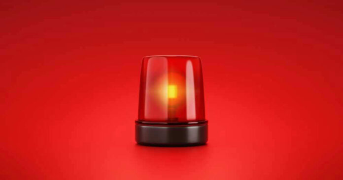 shutterstock_2053758056-1.jpg Red emergency light on solid red background