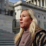Marjorie Taylor Greene standing outside a large building