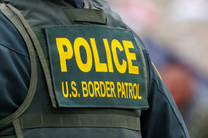 shutterstock_2331437679.jpg Back of US Border Patrol officers vest