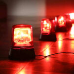 DISASTER Looms: City Braces for Glacial Flood Red emergency lights on dark floor illuminating the area