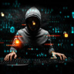 Hacker in dark room with code on screen