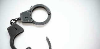 Open metal handcuffs on white background