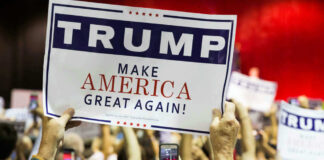 People holding Trump Make America Great Again signs