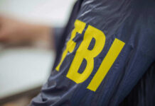 Person wearing FBI jacket letters in yellow