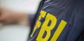 Person wearing FBI jacket letters in yellow