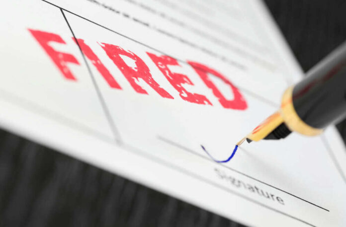 Fountain pen signing document with the word fired