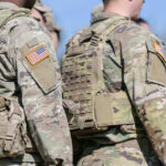 Trump Unleashes Military on Narco-Terrorists (Video) Soldiers in camouflage uniforms with American flag patches.