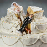 Wedding cake with bride and groom toppers, cake split