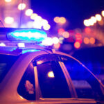 Cop Knifed Inside Precinct – Suspect Killed Police car with blue lights flashing at night