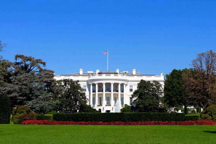 The White House with flags and trees