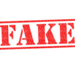 Red stamp with the word FAKE prominently displayed
