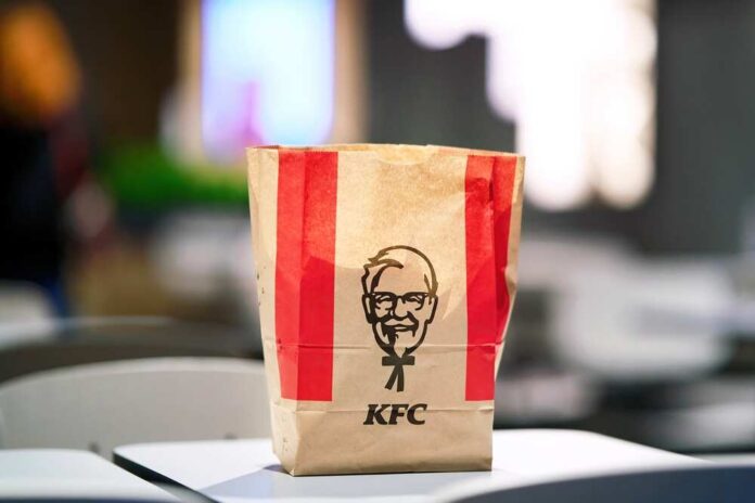 shutterstock_2636352349.jpg KFC takeout bag on a table in a restaurant