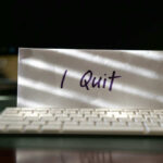 Top Admin Official QUITS After Catastrophic Failure Envelope reading I Quit behind keyboard.