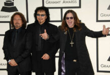 Ozzy Osbourne posing with Black Sabbath members