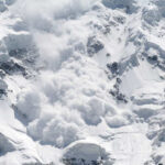 An avalanche cascading down a snowy mountain