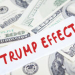 Text Trump Effect over hundred dollar bills