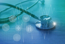 A stethoscope on a wooden surface with digital health icons and a heartbeat graph overlay