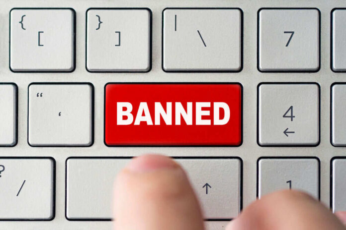 Red banned key on computer keyboard pressed