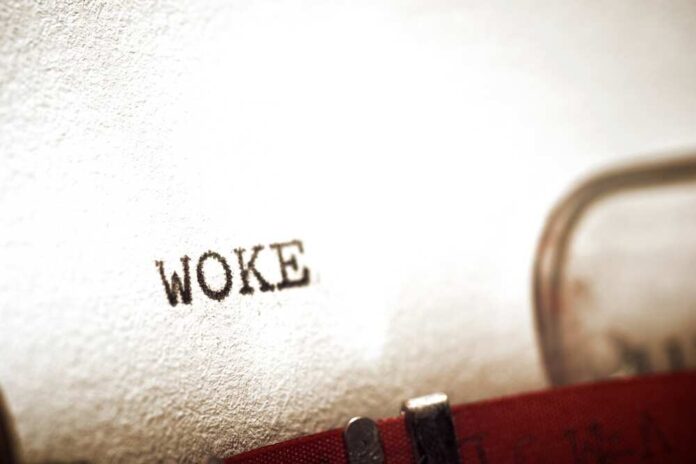 Close-up of the word 'WOKE' typed on paper from a typewriter