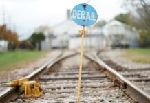 A blue derail sign on a railroad track
