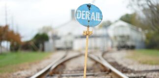 A blue derail sign on a railroad track