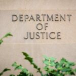 DOJ PURGES Epstein Files After Trump Photo Surfaces Sign displaying 'Department of Justice' on a stone wall