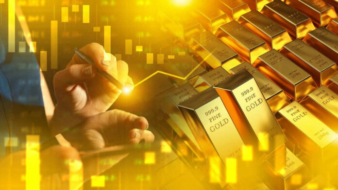 Hand writing near stacked gold bars and charts