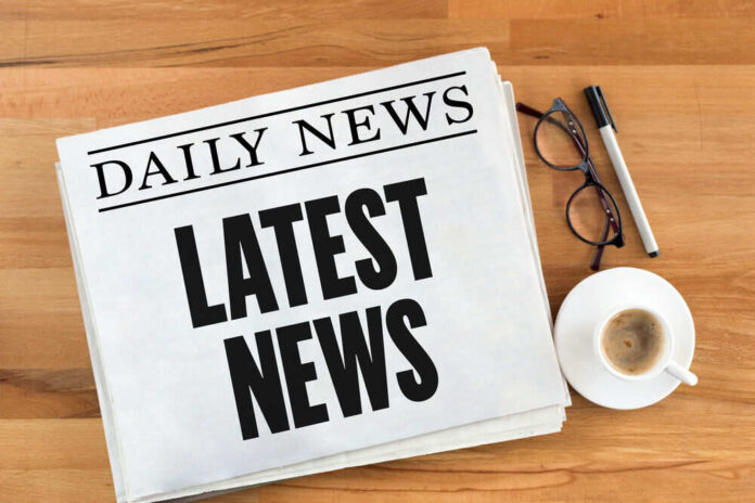 Newspaper with headline latest news on table
