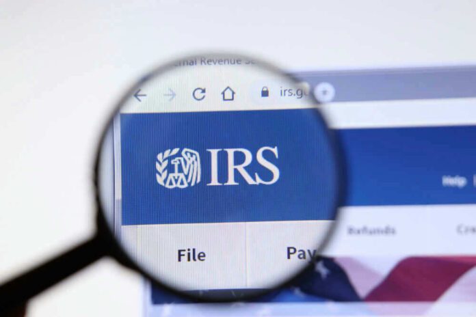 Magnifying glass focusing on IRS website logo.
