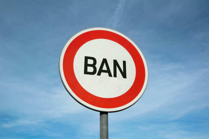 Sign reading BAN against blue sky background