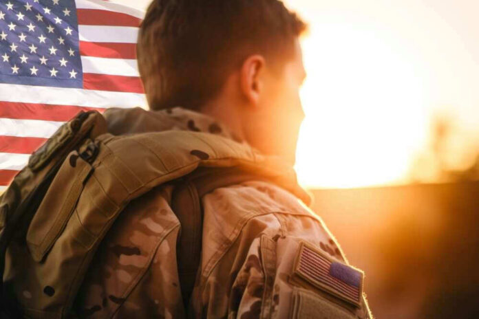 Soldier in uniform with American flag at sunset.