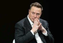 Elon Musk in suit thinking.