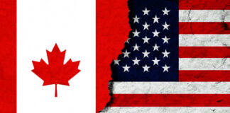 Canadian and American flags with torn dividing line